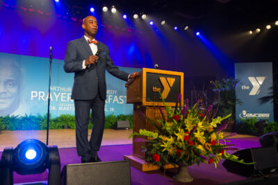 Man in church near YMCA wooden lectern