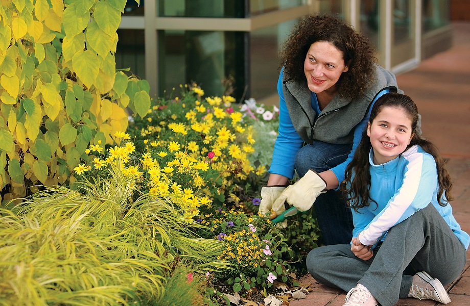 Adult and child gardening outside
