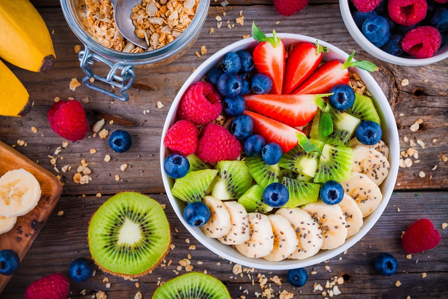 Smoothie Bowl with bananas, strawberries, blueberries, kiwis, and granola