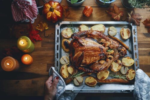 Turkey on Baking Sheet on Dining Table with Autumn Decor