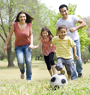 Family Playing Soccer Outside