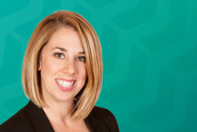 Headshot of Kristen Cole in front of green chevron background