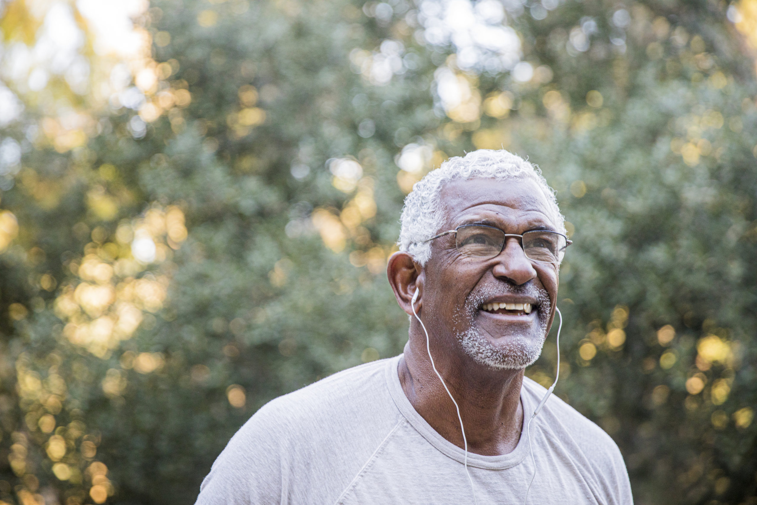 Man running outdoors with headphones in his ears
