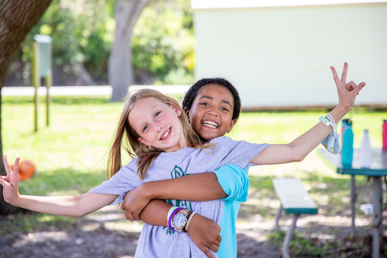 Girls hugging and having fun playing outside together