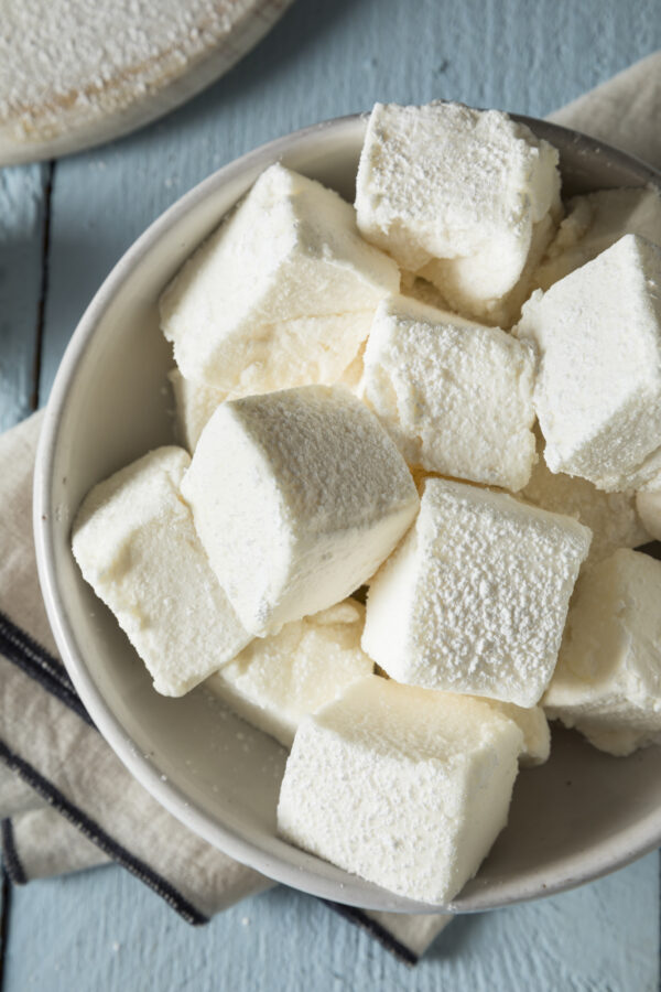 Homemade Marshmallows in White Ceramic Bowl on Blue Wooden Table