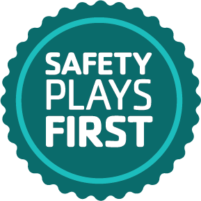 A teal green safety badge that says Safety Plays Here in white