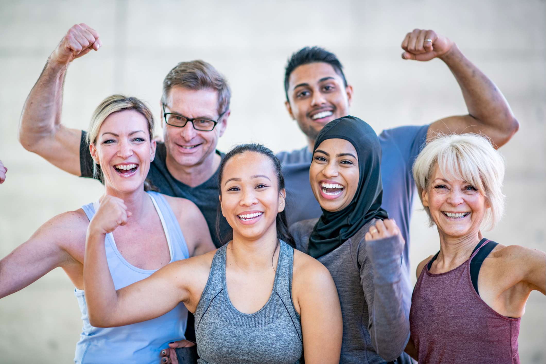 Diverse group of adults smiling after their wellness classes