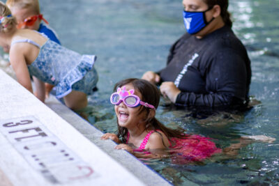 Girl swimming in the pool during swim lessons