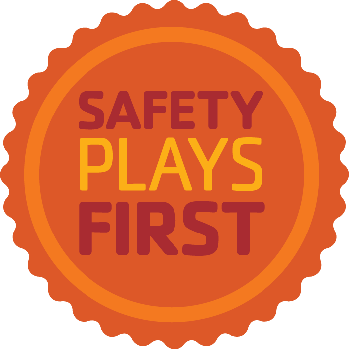 A orange safety badge that says Safety Plays Here in yellow and dark orange