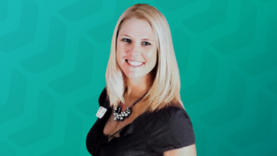 Headshot of Kelli Garcia in front of green chevron background