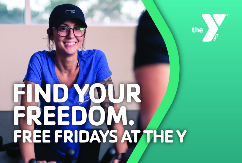 Woman riding cycling bike in group exercise class with the YMCA logo and the words Find Your Freedom. Free Fridays at the Y written in white