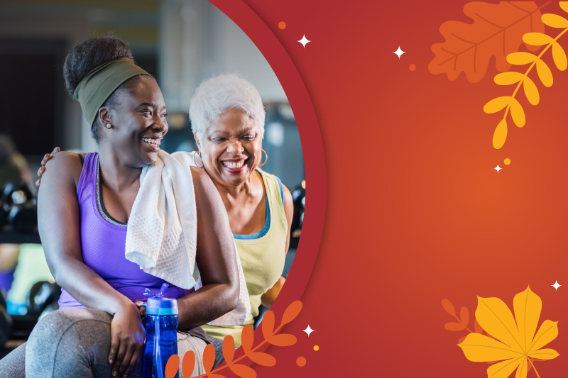 Photo of two women sitting on workout bench smiling in a circle with the red orange gradient beside them and illustrations of fall foliage