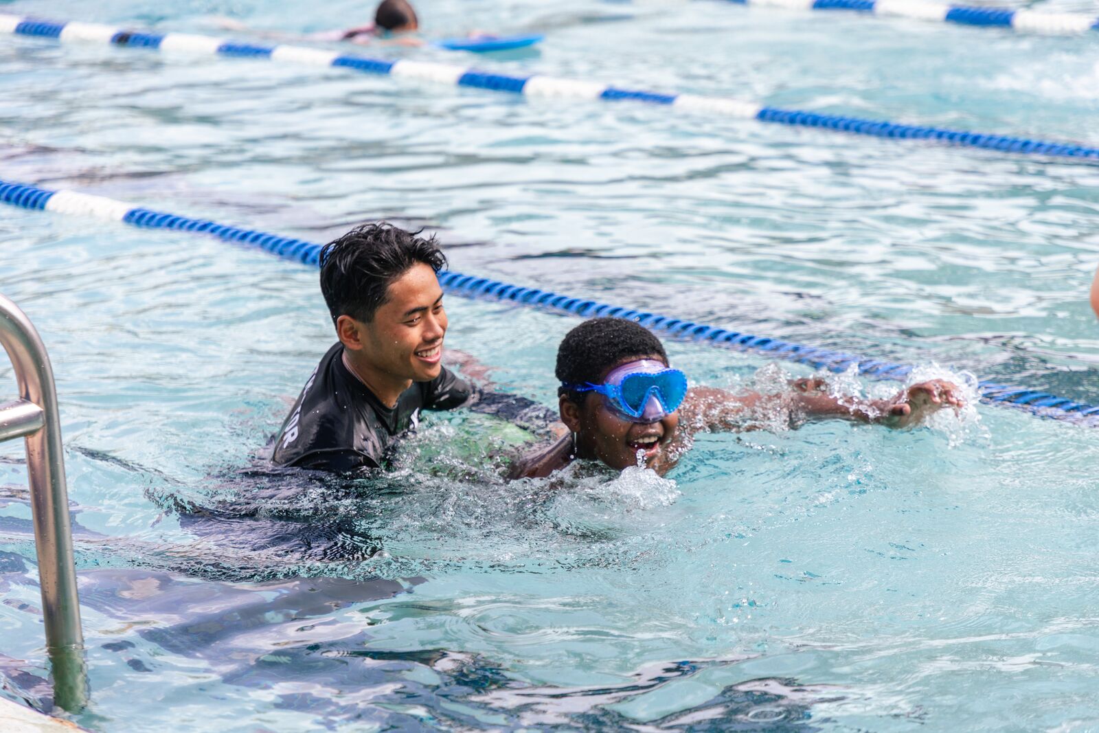 Image of man teaching boy to swim at Winter Park YMCA pool
