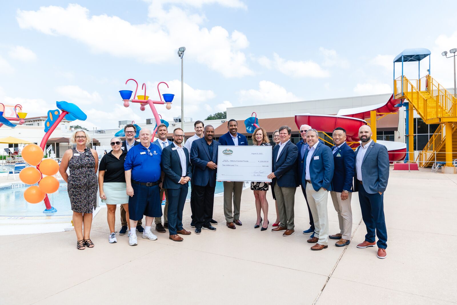 Photo of YMCA leadership and Dr Phillips Charities leadership presenting $2 million check at the Dr. P. Phillips YMCA pool