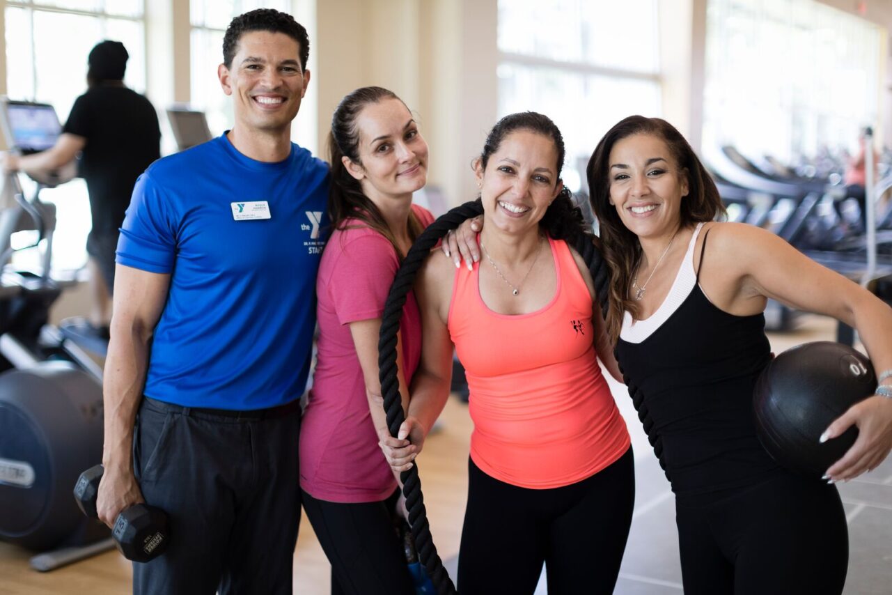 Three women and a Personal Trainer having fun on the fitness floor at the YMCA