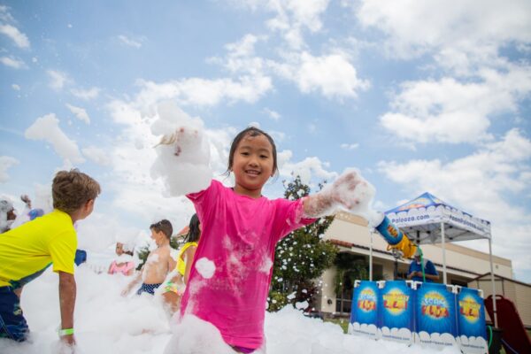 Kid covered in bubbles at YMCA camp in Orlando