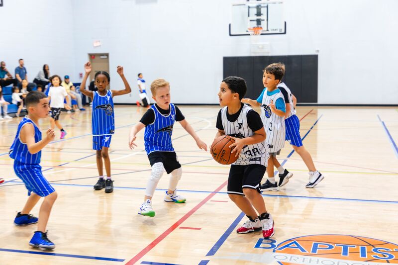 Boys playing basketball at the YMCA youth basketball league