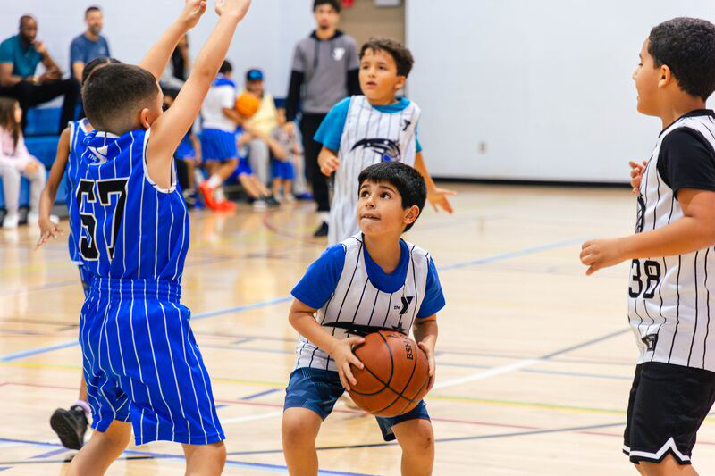 Boy getting ready to shoot during the YMCA's Basketball Recreational League game