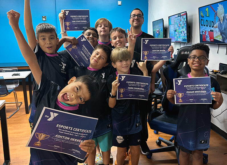 YMCA Esports league players showing off their awards