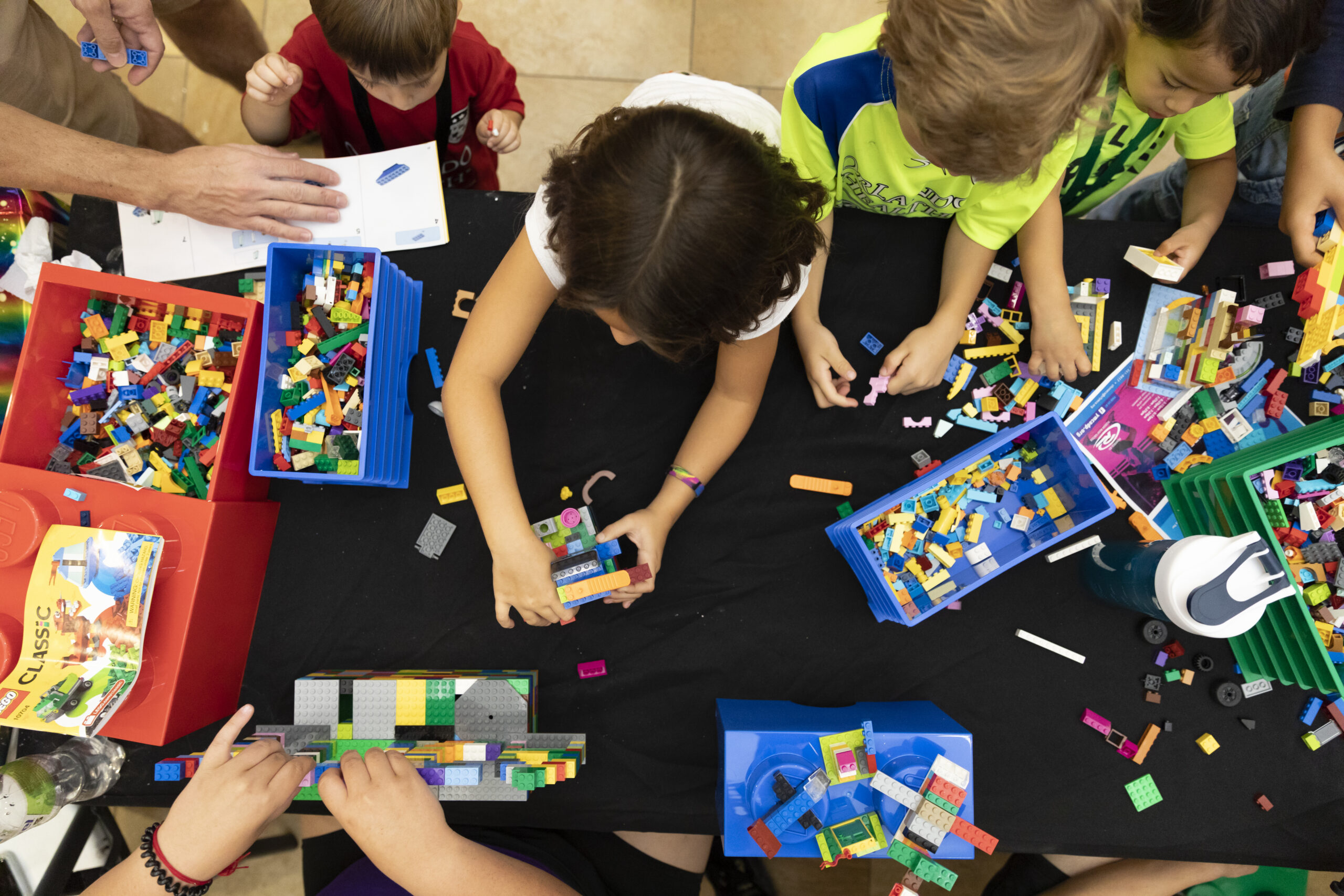 Aerial view of kids gathered around a table doing crafts at the YMCA.