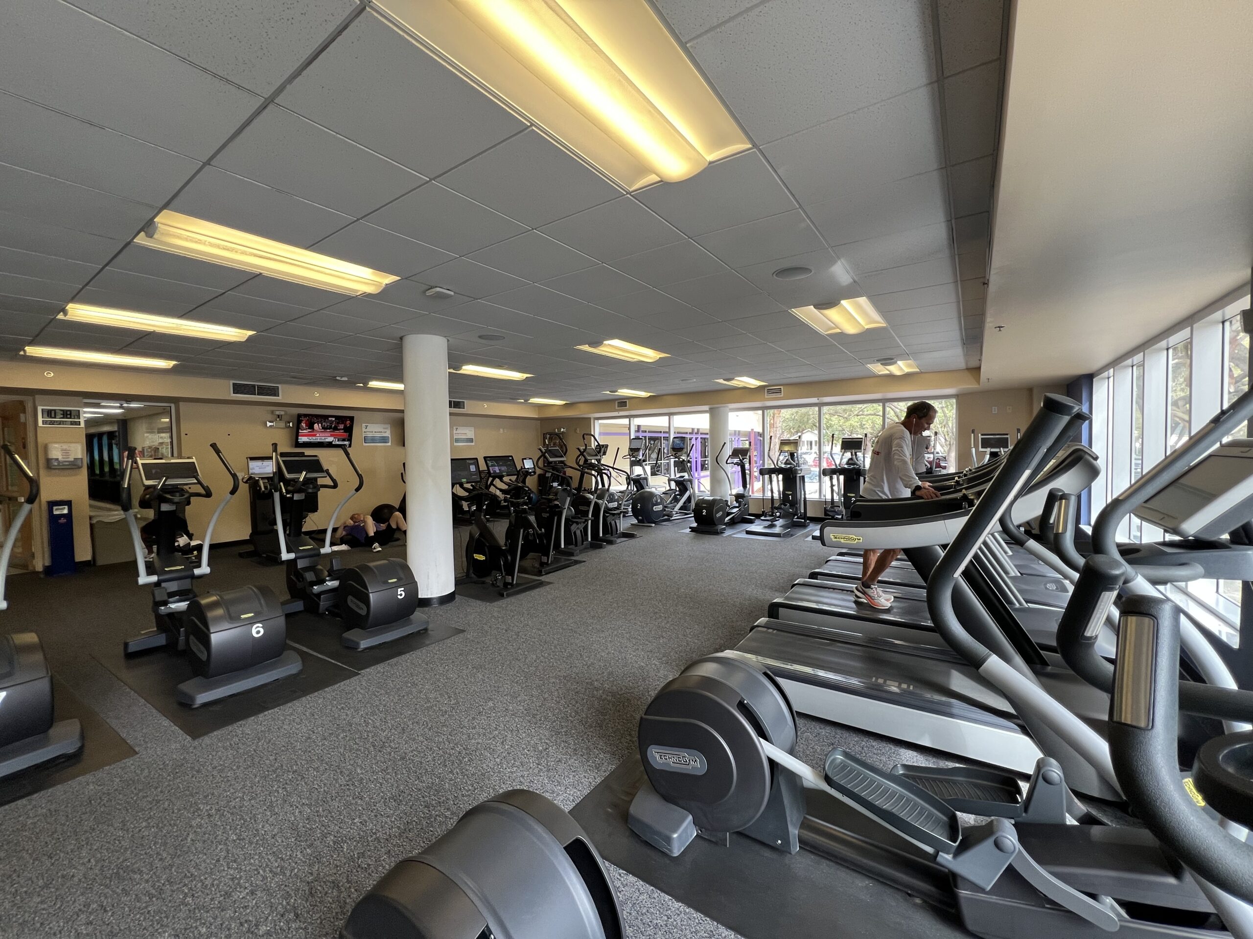 Fitness equipment on the wellness floor at the YMCA, with machines and benches but no people.