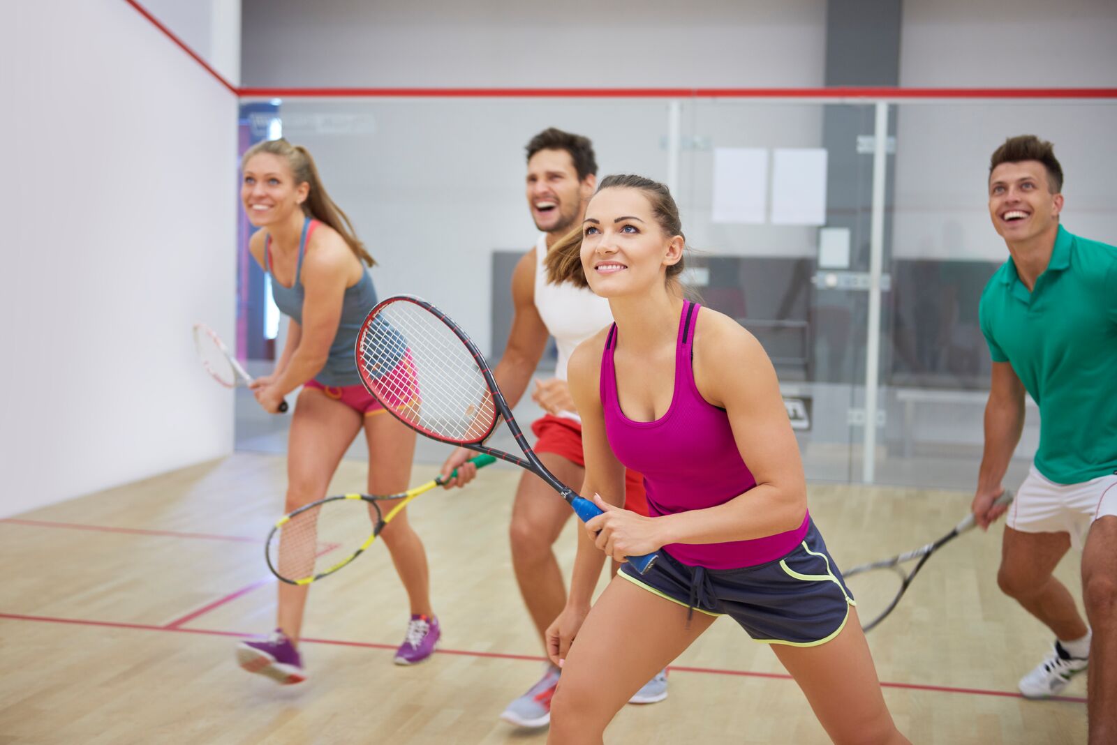 Four adults playing a pick-up game at the YMCA.