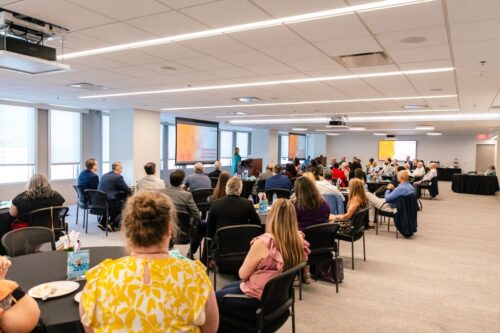 Wide shot of attendees sitting at tables at the YMCA of Central Florida's Annual Meeting in May 2025 in Orlando, FL