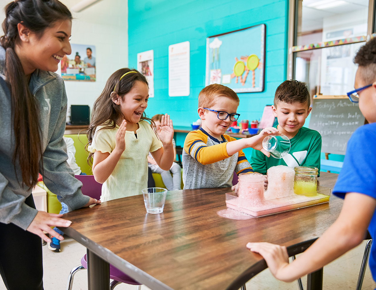 Group of kids working on exploading science experiment during the YMCA after school program