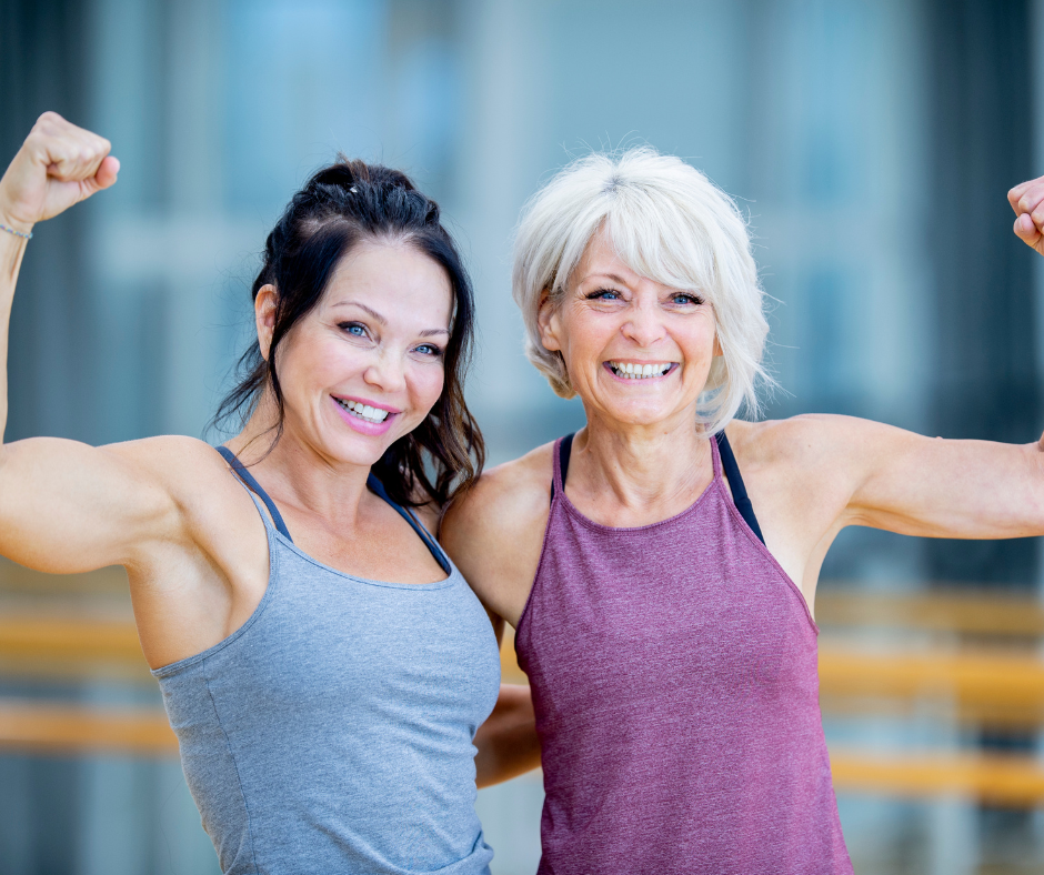 Two women exercising together at the YMCA with a personal trainer, participating in the Fast Forward Fitness program.