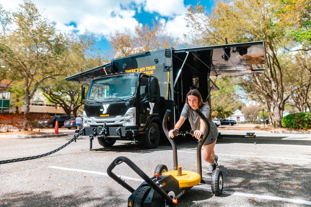 Teen working out using the YMCA Fit Truk equipments