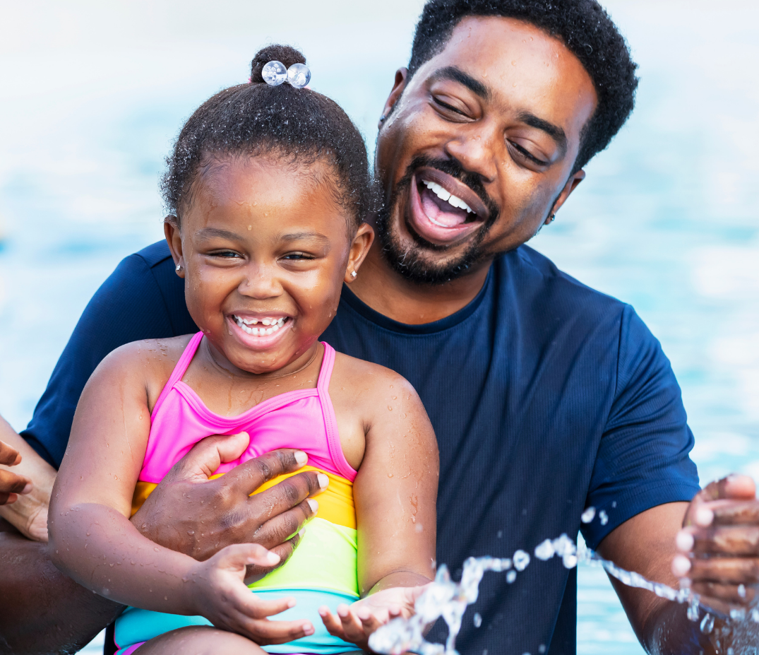 Image of a father and daughter in a YMCA pool.