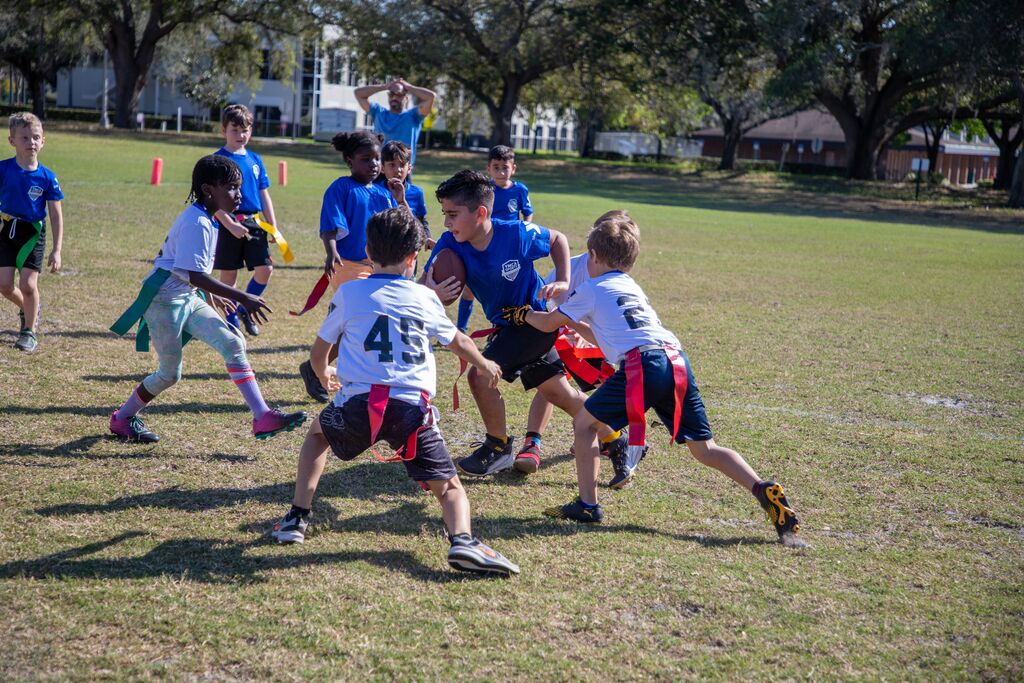 Kids playing co-ed flag football for the YMCA league