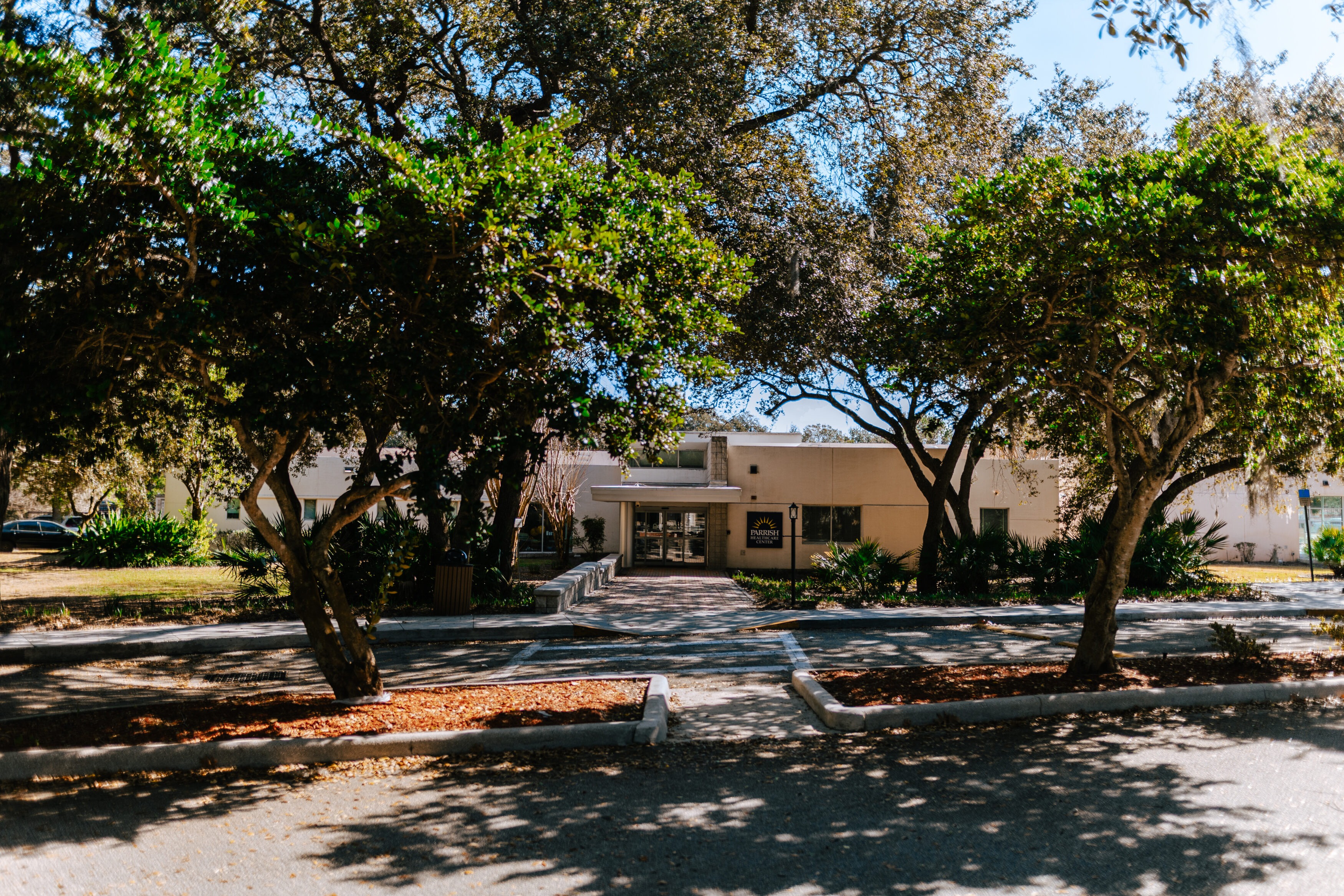 Front entrance of Parrish Health & Fitness Center operated by the YMCA, with clear signage and landscaping.