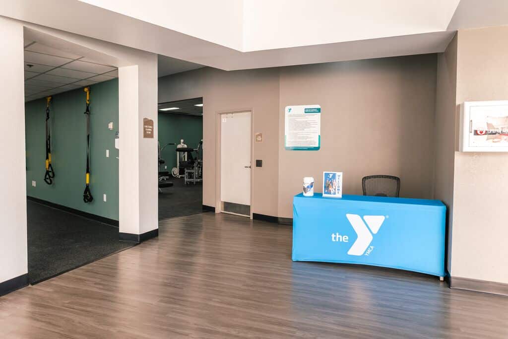 Entrance of Parrish Health & Fitness Center, operated by the YMCA of Central Florida, with signage and welcoming lobby area.