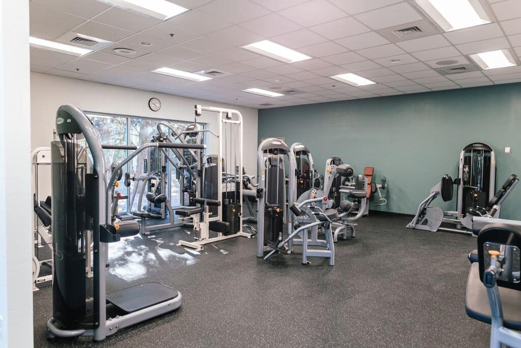 Various fitness equipment including machines and benches at Parrish Health & Fitness Center, operated by the YMCA of Central Florida.