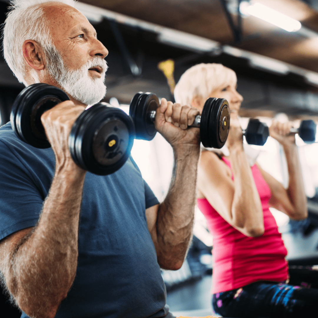 A senior man and woman lifting weights together at Parrish Health & Fitness Center, operated by the YMCA of Central Florida, staying active and healthy.