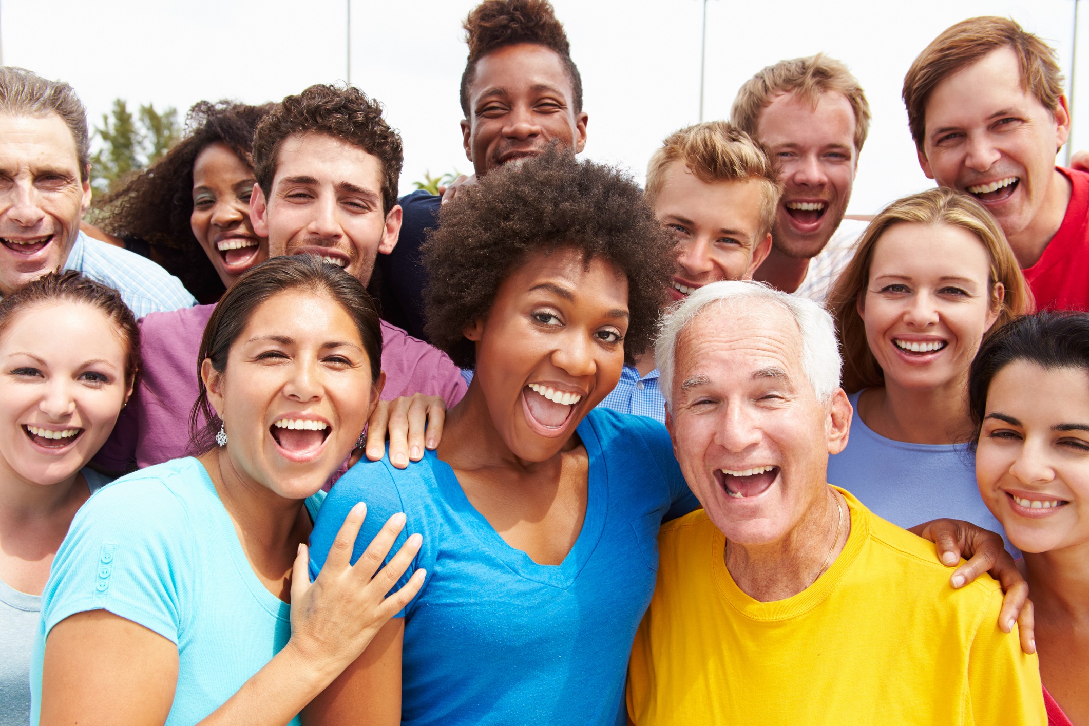 A diverse group of YMCA members smiling and interacting together at the Y