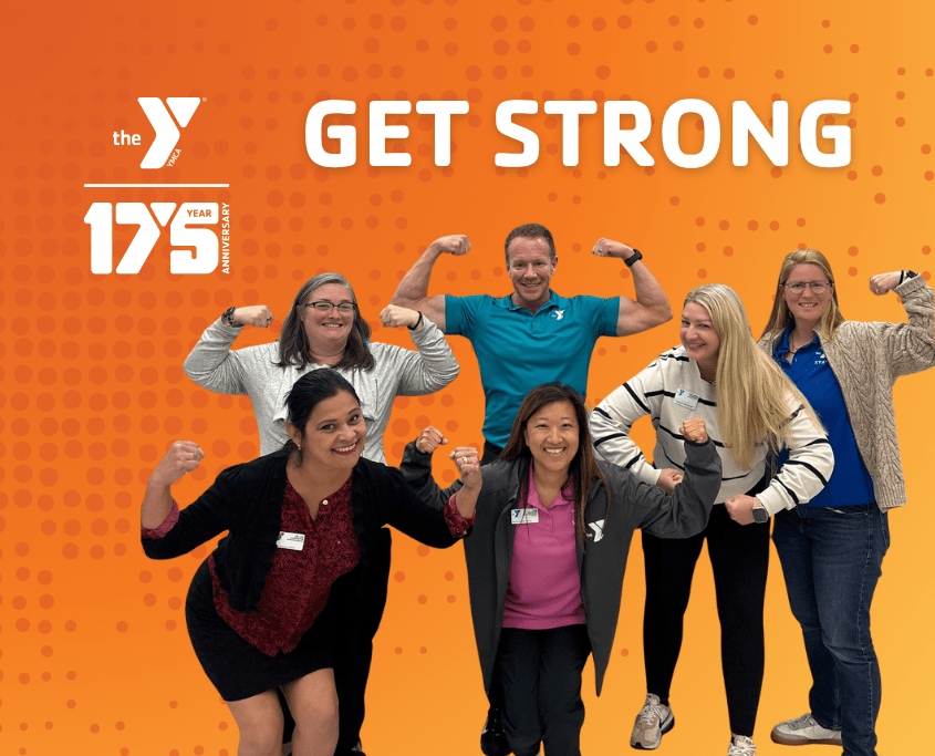 A group of YMCA leaders smiling and making a muscle pose together, representing strength, teamwork, and community support.