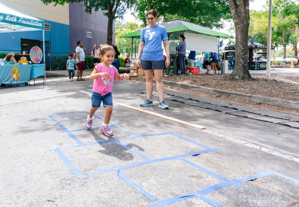 Child playing outside during Healthy Kids Day at the Downtown YMCA.