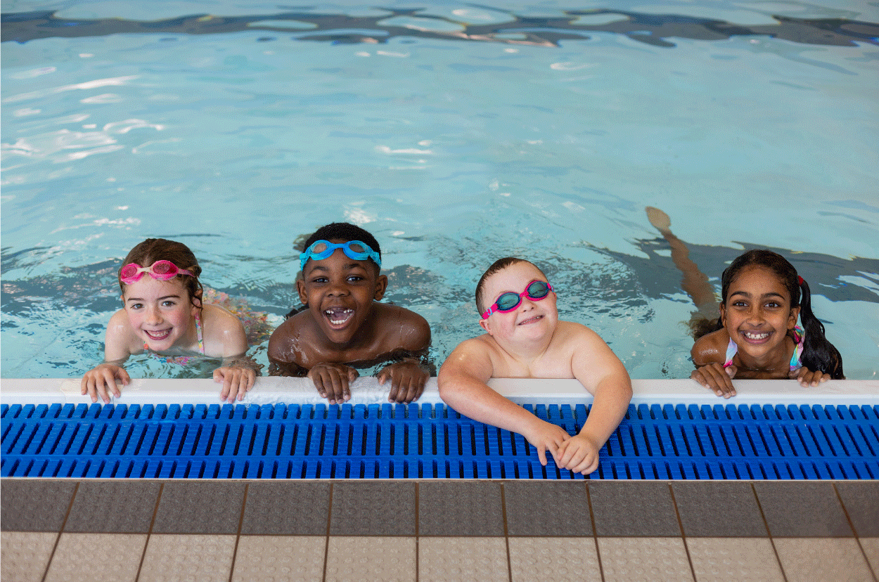 Children swimming in a pool, one boy has Downs Syndrome