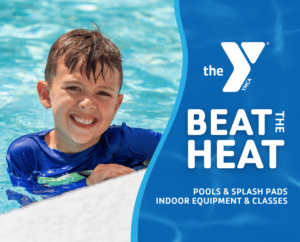 Child smiling and enjoying the water in a YMCA pool during summer swim activities