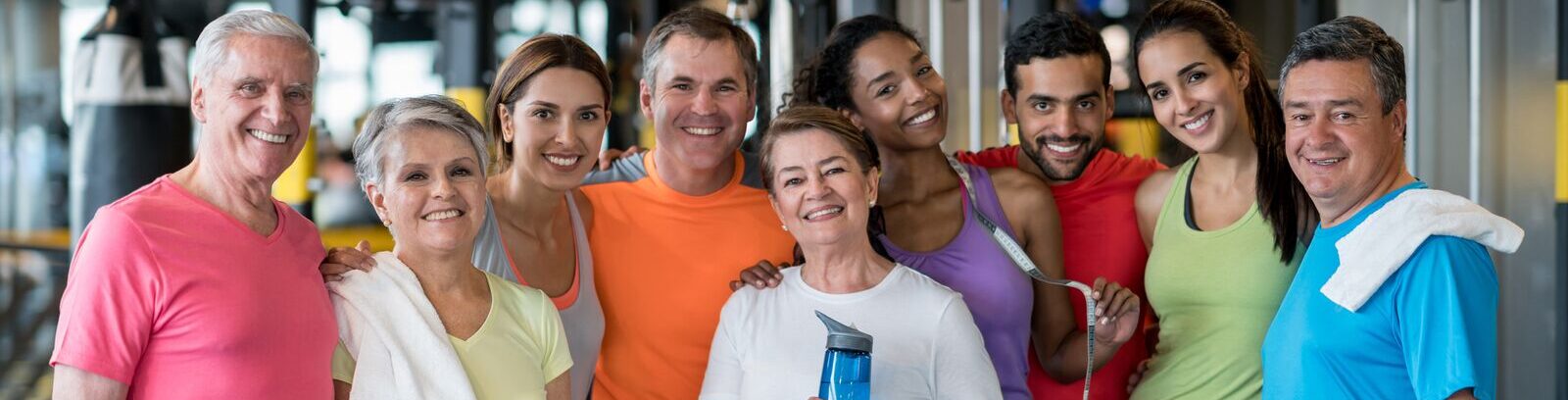 Older adult YMCA member smiling while using fitness equipment in a YMCA Wellness Floor.