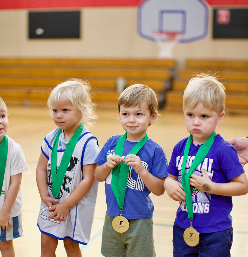 Toddlers receiving sports awards in the YMCA Rising Stars Preschool Sports program