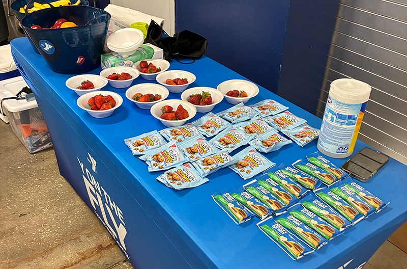 Y on the Fly healthy snack table set up at a community center